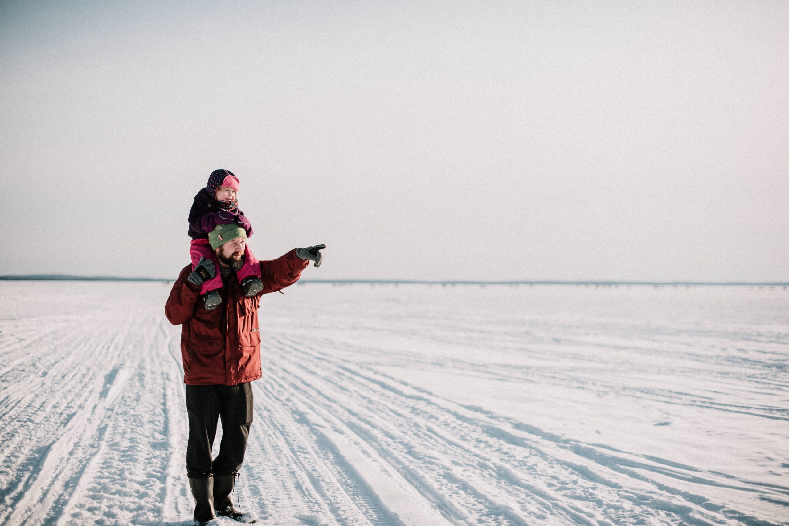 Father and Daughter walking on frozen Lake Nipissing