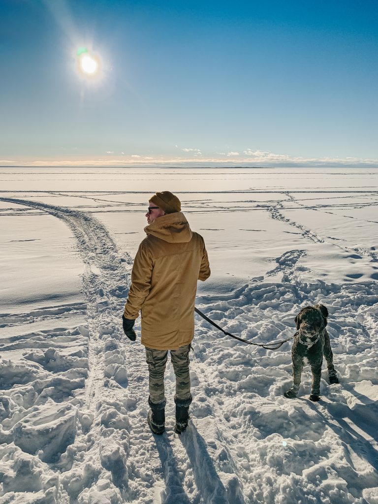 Man with dog on frozen Lake Nipissing